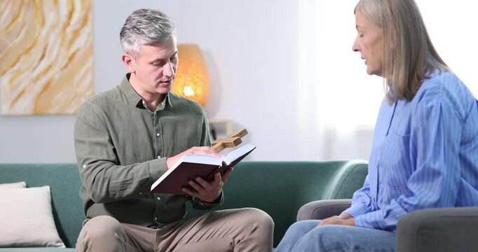 Pastor conducting Bible study with senior woman at home