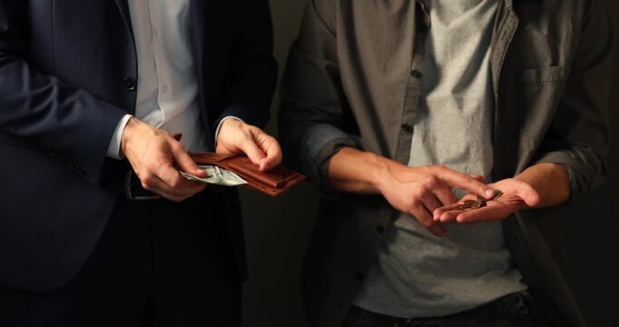 Wealth and poverty. Poor man counting coins and businessman with dollars on dark background, closeup