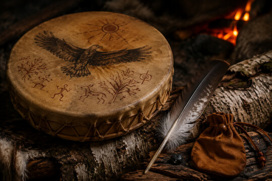 Shamanic frame drum with painted hide on birch log, spiritual and ritual tradition concept