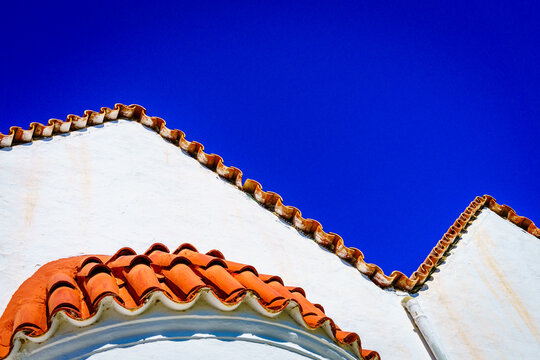 Greek church roof tiles against blue sky Crete Greece