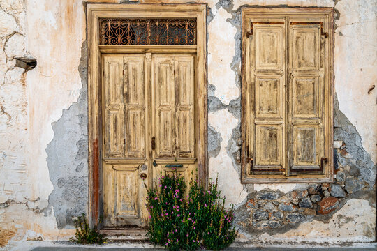 Weathered wooden door and window on old Cretan house Crete Greece