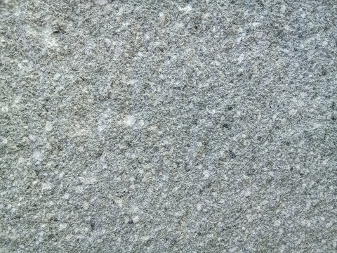 Full frame natural grey granite stone texture background with fine rough mineral grain details