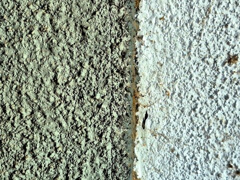 Extreme close up macro texture of rough white and grey stucco concrete wall