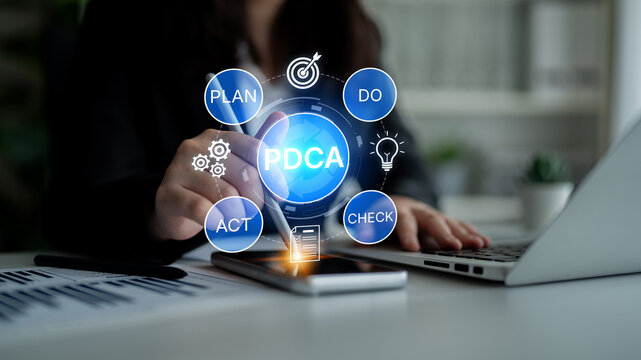 Business Professional Engaging in PDCA Cycle with Digital Interface Displaying Key Elements for Continuous Improvement and Quality Management in Office Setting. Bitwise.