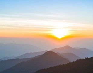 Obraz premium Beautiful sunrise over layered mountain silhouettes in the morning.