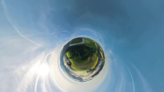 Creative drone footage of the Danube Valley in Upper Austria transforming from a tiny planet view into an inverted planet effect, creating a surreal perspective of the river and green landscape.