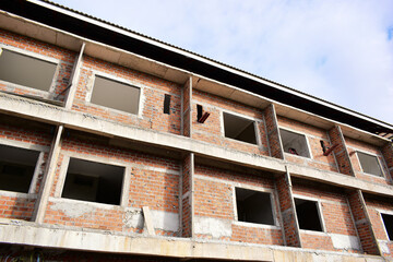 Obraz premium exterior view of brick house under construction with concrete structure