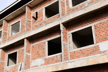 Obraz premium exterior view of brick house under construction with concrete structure