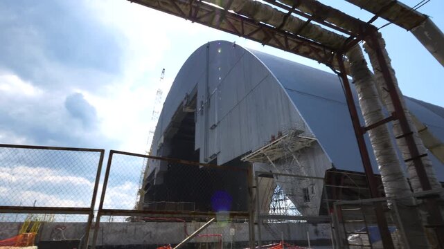 A camera pans across the Chernobyl New Safe Confinement construction site.