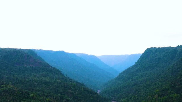 Scenic landscape of blue toned Mawkdok Dympep Hill Valley. East Khasi Hills of Meghalaya, India - Aerial panning shot.