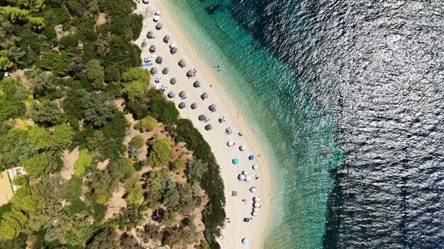 Famous and jaw-dropping Aspros Gialos beach, Ithaca, Greek Islands - drone flyover, gimbal down