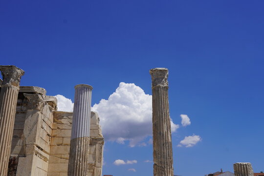 Ancient columns with corinthian order capitals, against a blue sky, in the Roman Agora, in Athens, Greece