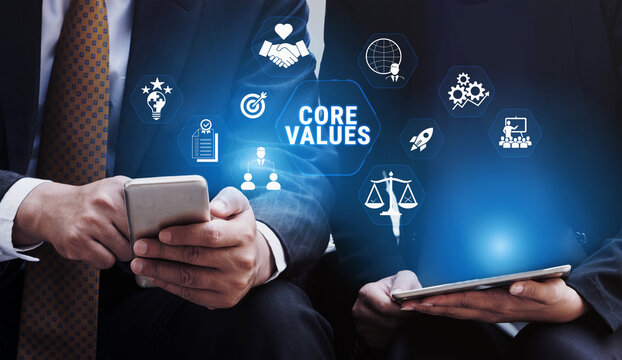 Business Professionals Engaging with Core Values Concept on Digital Devices While Displaying Symbols of Integrity, Trust, and Communication in a Modern Office Setting Fluxor.