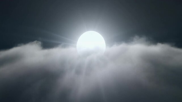Bright glowing full moon rising above dense layers of fluffy white clouds in the night sky