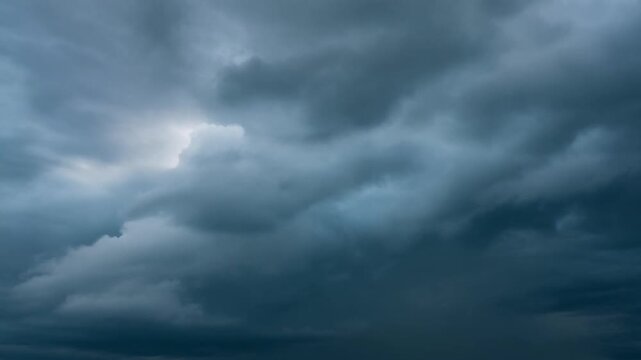 Dramatic dark storm clouds filling the sky before a heavy rainfall, creating a moody atmosphere