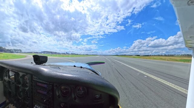 Small airplane used by a hobby pilot is leaving the runway and taxiing on the taxiway during a sunny day at an airport