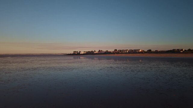 Isle of Sheppey, Leysdown Beach coastline at solar eclipse sunset, natural phenomenon event captured across the globe, wide aerial panorama