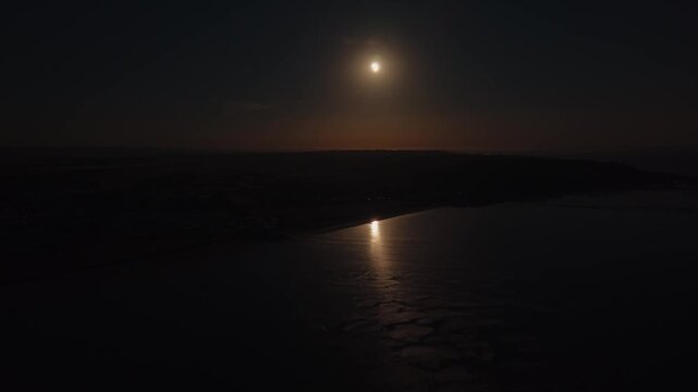 Solar Eclipse darkness covers Leysdown Beach coastline on the Isle of Sheppey, natural phenomenon event captured across the globe, wide aerial panorama