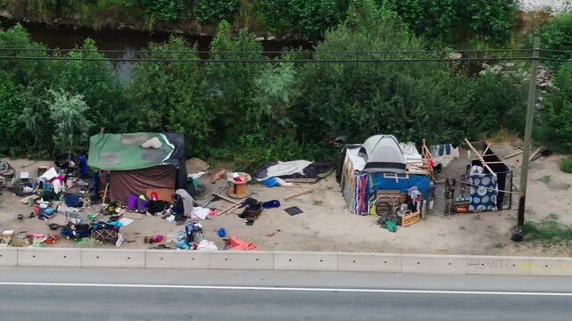 Homeless encampment beside a busy road