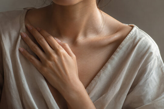 Somatic healing concept with close up of woman hand on chest showing calm and gentle touch for emotional and physical wellness