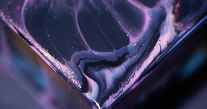 Sparkling fluid. Ink spill. Defocused blue purple pink color glitter triangle mix acrylic texture floating on abstract art background.