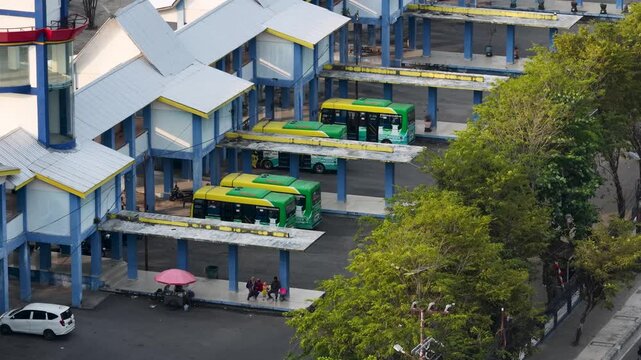 Buses parked at a terminal station under a bright day in Banjarmasin, South Kalimantan, Indonesia