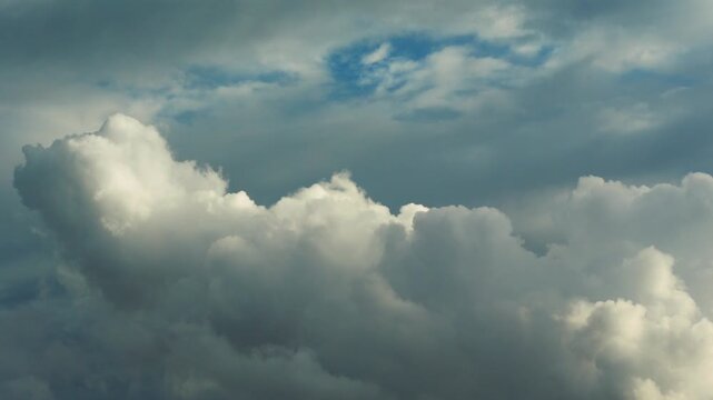 White clouds time lapse. Clouds running across the blue sky. 4k Time lapse of white clouds with blue sky background. Weather concept b roll shot.