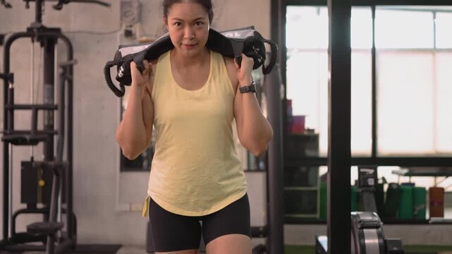 Hyrox race strong tough carry heavy effort HIIT indoor sport active asia people young Gen Z woman self care. High VO2 max cross power full core body muscle weight loss anti aging modern gym living.