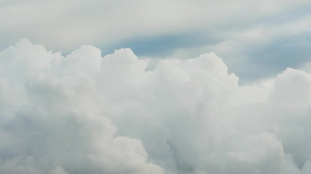White clouds time lapse. Clouds running across the blue sky. 4k Time lapse of white clouds with blue sky background. Weather concept b roll shot.