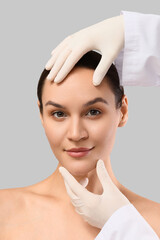 Cosmetic surgery and facial rejuvenation, doctor examining woman skin for plastic surgery procedure...