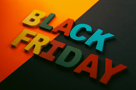 Black Friday text made with colorful wooden letters on black