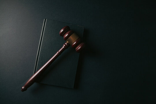 Judge gavel and book on black background. Law and justice concept.