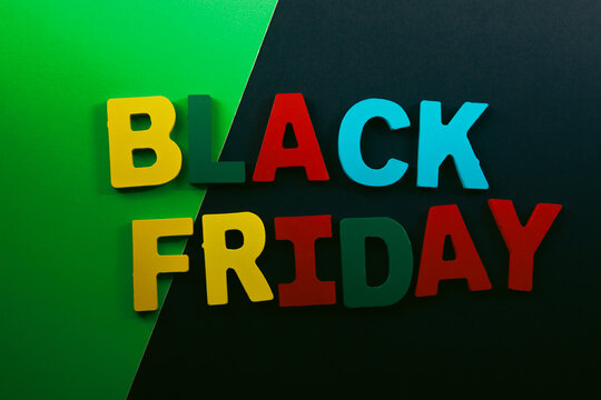 Black Friday text made with colorful wooden letters on black