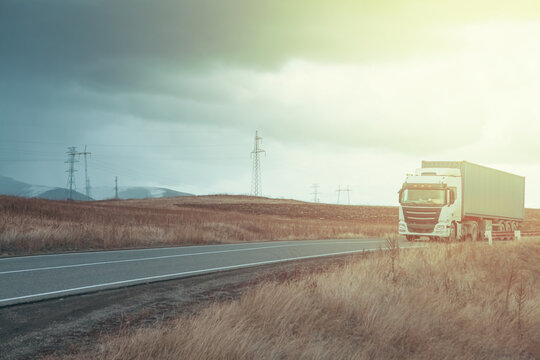 Truck on the road in the field.