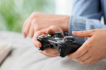 Gaming and entertainment person playing video games with a controller at home for leisure relaxation and digital hobby lifestyle in a living room © Pixel-Shot