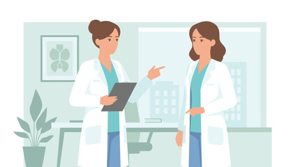 Fototapeta premium Two female medical doctors in white lab coats actively discussing clinical reports in a bright modern hospital office.