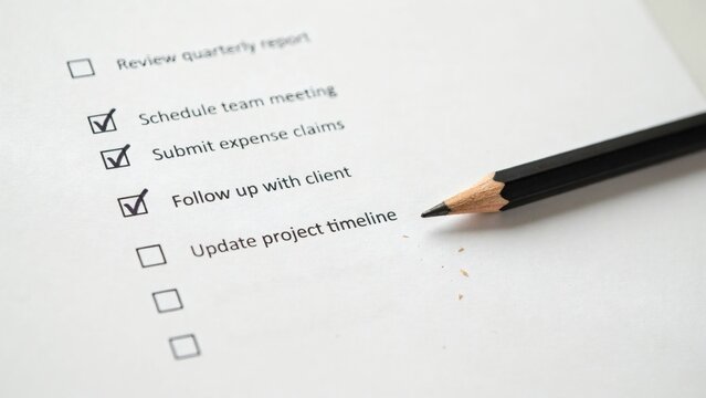 Completed office checklist with pencil and unchecked tasks