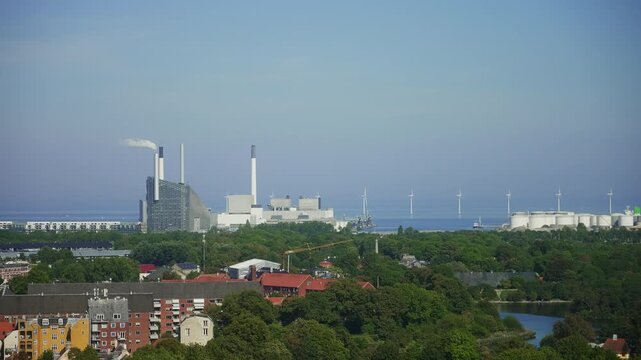 Panoramic view of Copenhagen featuring Amager Bakke (CopenHill), offshore wind turbines and the modern waterfront, highlighting sustainable infrastructure and renewable energy.
