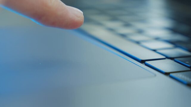 Finger touching pad on laptop computer with fingerprint recognition technology authorizing or identifying user with ID. Entering system or confirming process in user interface. Hacker or spy in office
