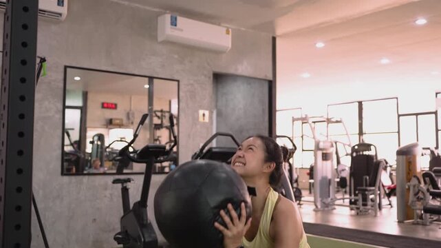 Hyrox race wall ball strong tough heavy effort HIIT indoor sport active asia people young Gen Z woman self care. High VO2 max cross power full core body muscle weight loss anti aging modern gym living