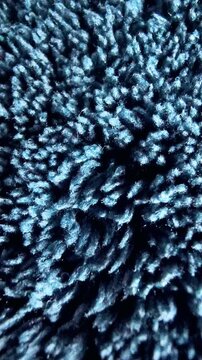 Blue abstract background, macro close up view of micro fiber textile fabric texture with soft plush surface and dense fibers.