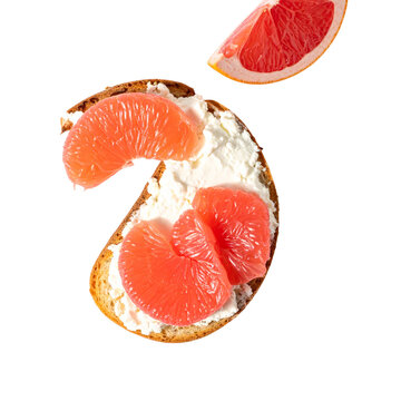 Toasted sourdough bread smeared with smooth ricotta cheese and garnished with sweet tart pink grapefruit citrus slices