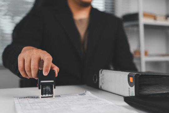 Business contract document stamping with approval seal, agreement verification, official paperwork process, legal compliance and corporate documentation concept.
