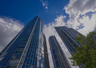 Fototapeta premium Contemporary residential architecture featuring curved glass balconies and modern design along the River Thames waterfront in London, England.