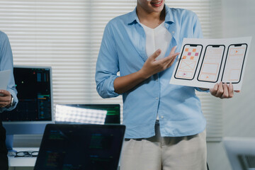 Developer presenting mobile app UX wireframes in office meeting