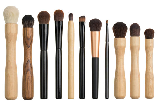 Collection of various cosmetic makeup brushes with wooden and black handles arranged in a row for beauty... isolated on a transparent background