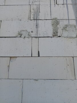 Unfinished lightweight concrete block wall texture background for industrial construction design projects.