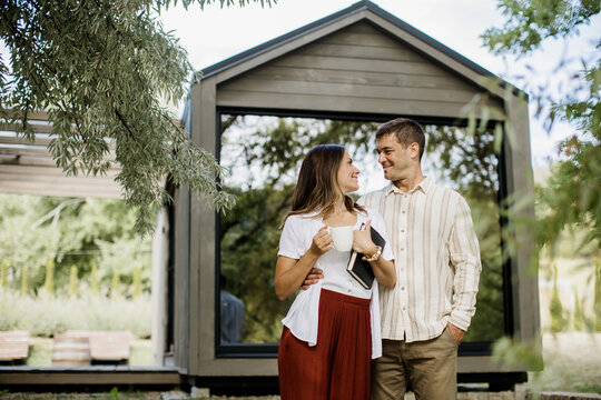 Couple enjoying a moment together near a modern house in nature