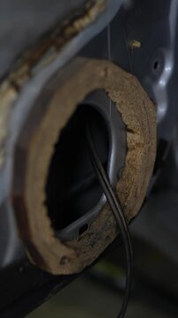 Wooden adapter ring installed on a car door for speaker.
