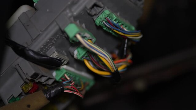 Honda car fuse box with connected colorful electrical wiring harness.